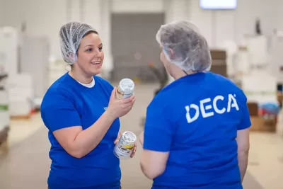 Two production workers of DECA talking about products